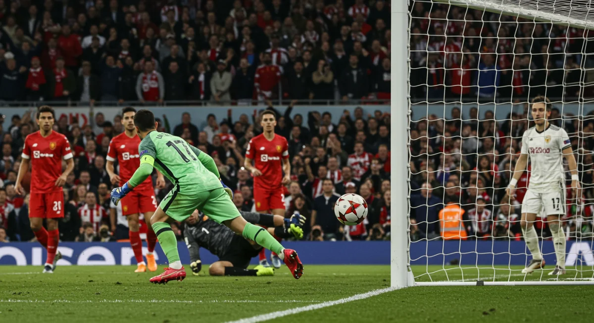 Soccer ball scoring a game-winning goal, hitting the net with a diving goalkeeper.