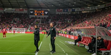 Bundesliga coach making tactical adjustments during a thrilling comeback match