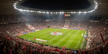 Bundesliga Fan Engagement Strategies: Boosting Attendance in 2025 Aerial view of a vibrant, packed Bundesliga stadium at night with cheering fans and bright lights.