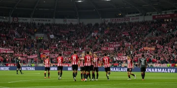 Underdog team celebrating a goal in a vibrant Bundesliga stadium, symbolizing a potential breakthrough season.