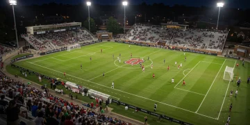 2025 College Soccer Season: Key Dates & Deadlines for Athletes & Coaches Dynamic college soccer match under stadium lights with players and fans