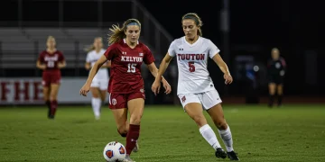 College soccer player demonstrating mental focus on the field