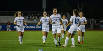 College soccer players celebrating a goal with NIL branding overlay