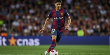 Young La Liga star dribbling football with intensity on pitch