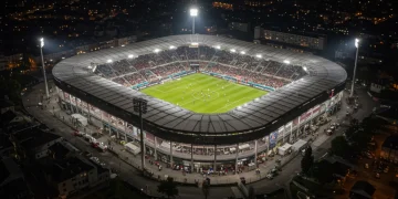 Modern French football stadium showcasing increased investment and vibrant atmosphere.