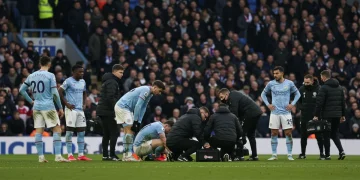 Premier League players receiving urgent medical attention on the field during a match, highlighting the ongoing injury crisis.