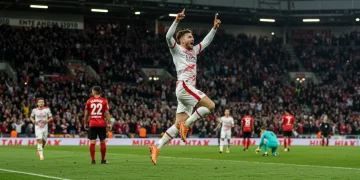 Unexpected Goal Scorers: European League Impact & Prospects Football player celebrating an unexpected goal in a European league match, arms raised in triumph.