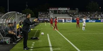 Coach making a tactical substitution in a high-stakes USL Championship match